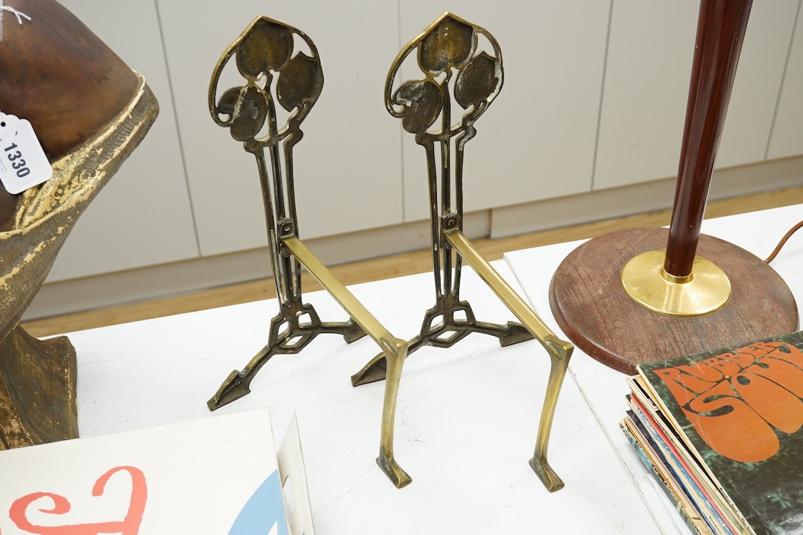 A pair of Art Nouveau brass firedogs, 35cm high